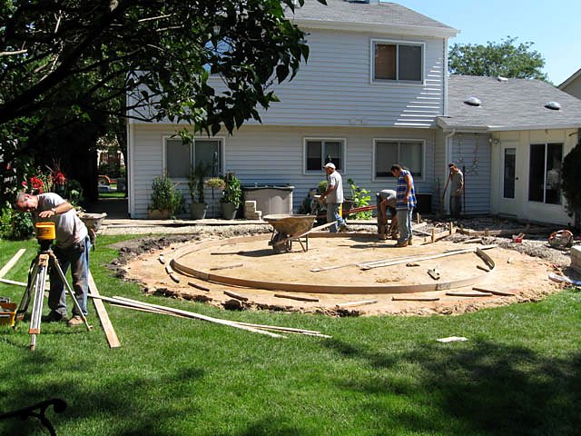 Concrete crew forming and pouring a circular patio