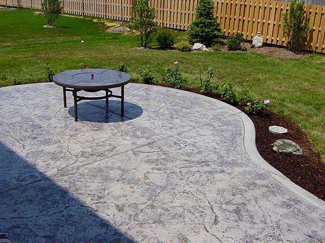 A stamped concrete patio with a built-in fire table, poured by my client.