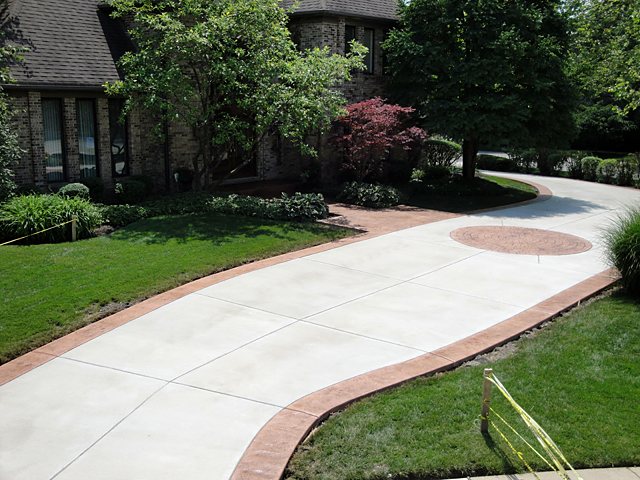 A stamped concrete driveway with a medallion, poured by my client.