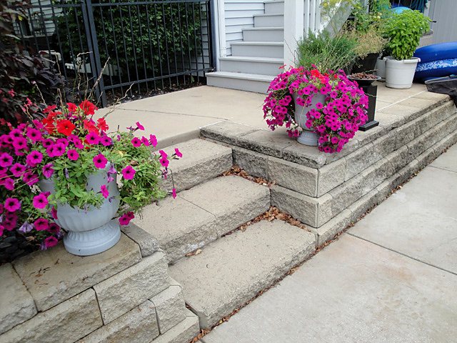 Stamped concrete front steps leading up to a home entrance