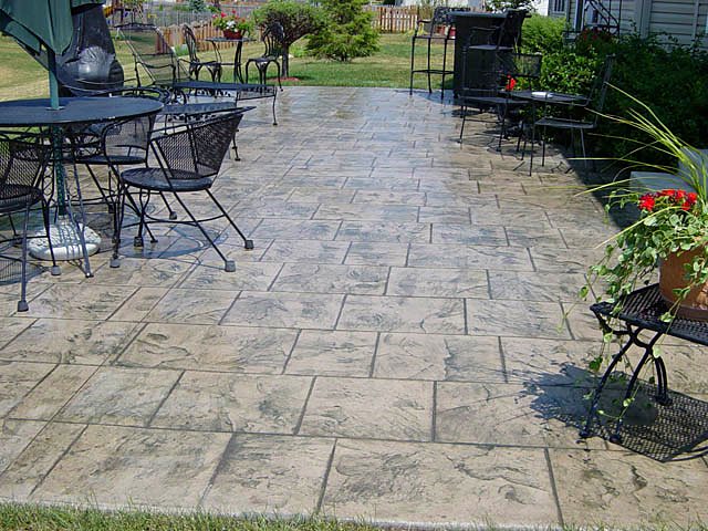 Stamped concrete patio set up with an outdoor dining table